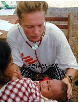 Doctors Without Borders worker examines baby in Dili